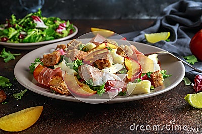 Fresh grilled peach salad with green mix, cheese, prosciutto and crouton Stock Photo