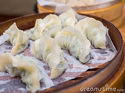 Fresh gyoza steamed Korean dumplings Mandu on bamboo steamer Stock Photo