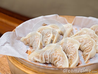 Fresh gyoza steamed Korean dumplings Mandu on bamboo steamer Stock Photo