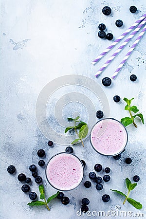 Fresh healthy blueberries smoothie berries and mint in glass on light white concrete background. Stock Photo