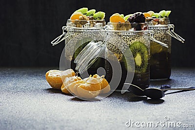 Fresh and healthy chia pudding in a jar with fruits and nuts on the top Stock Photo