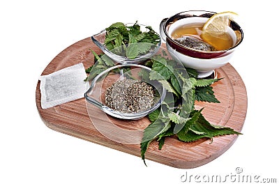 Fresh healthy nettle plant, dried herbs and hot tea Stock Photo