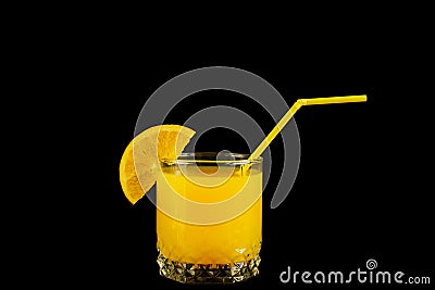 Fresh healthy orange juice in a glass with citrus slice and straw on black background Stock Photo