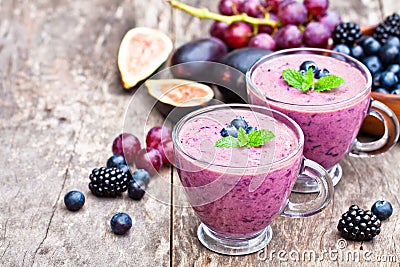 Fresh healthy pulpy cocktail with purple fruits and berries Stock Photo