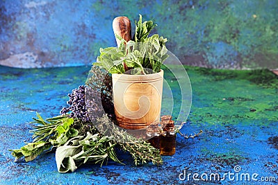 Fresh herbs from the garden and the different types of oils for massage and aromatherapy on table with lavender Stock Photo