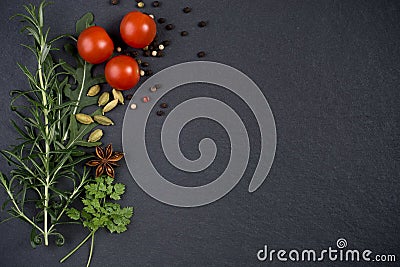 Fresh herbs and spices on dark slate background Stock Photo