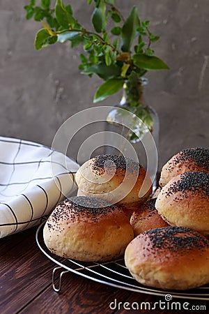 Fresh homemade burger buns with popp yseed, concept of burger and homemade food. Mini challah. Homemade bread on brown and grey ba Stock Photo