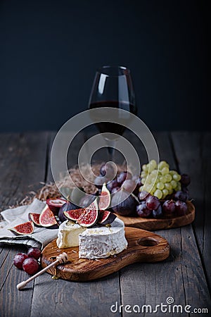 Fresh homemade camembert cheese with fresh fruits and glass of red wine Stock Photo