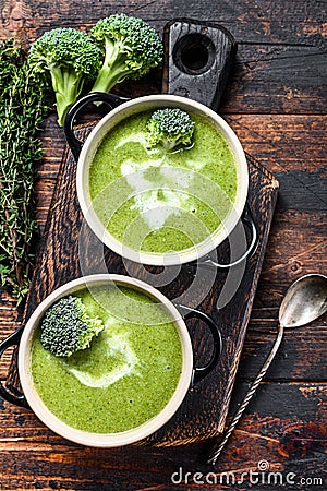 Fresh homemade cream broccoli soup in bowl . Dark Wooden background. Top view Stock Photo