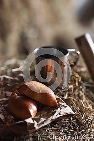 Fresh homemade meat patty cakes and steel cup on hayloft Stock Photo