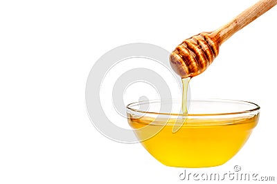 Fresh honey dripping from a spoon. On a white background. Stock Photo