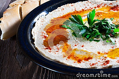 Fresh hummus with parsley. Stock Photo