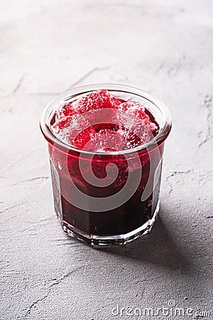 Fresh ice cold fruit cocktail in glass, refreshing summer red currant berry drink on stone concrete background Stock Photo