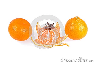 Fresh juicy bright mandarin decorated with anise and vanilla sticks on a white background. Stock Photo