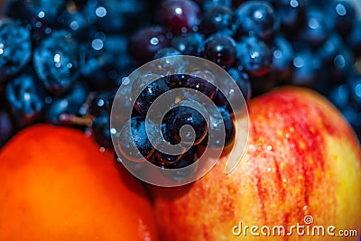 Fresh juicy fruits blurred background, grape, apple, persimmon. Stock Photo