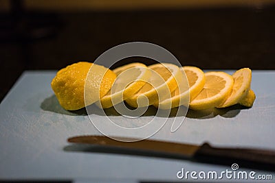 Fresh juicy lemon. Slice thin slices on a cutting board Stock Photo