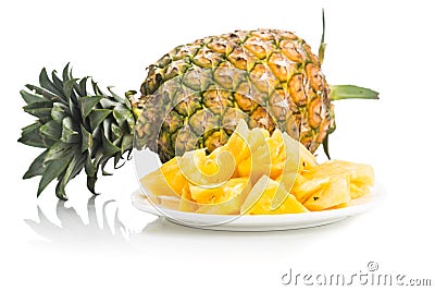 Fresh juicy nutritious cut pineapple with whole fruit as backgro Stock Photo