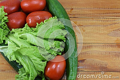 Fresh juicy red tomatoes, cucumbers and lettuce Stock Photo