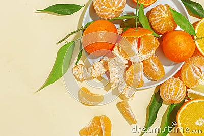 Fresh juicy tangerines on a yellow background. Summer mood, healthy food. Top view Stock Photo