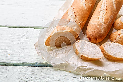 Fresh long loaf on paper Stock Photo