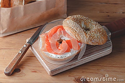 Fresh made Bagel with Salmon on old wooden table Stock Photo