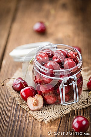 Fresh made Preserved Cherries on a rustic background Stock Photo