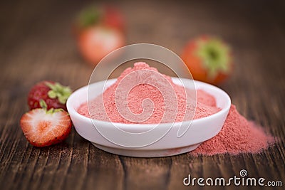 Strawberry powder on wooden background; selective focus Stock Photo