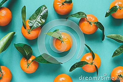 Fresh mandarins with leaves on turqoise background Stock Photo