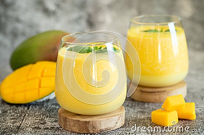 Fresh mango lassi in glasses on grey background with copy space Stock Photo