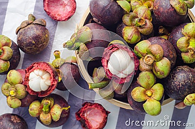 Fresh mangosteen fruits in the basket on paper background. Stock Photo