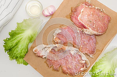 Fresh meat. Raw pork steak with spices on white background Stock Photo