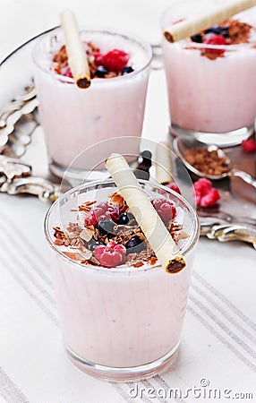 Fresh milkshake, yogurt, dessert, smoothie with strawberry decorated grated chocolate and frozen raspberries, blueberries Stock Photo