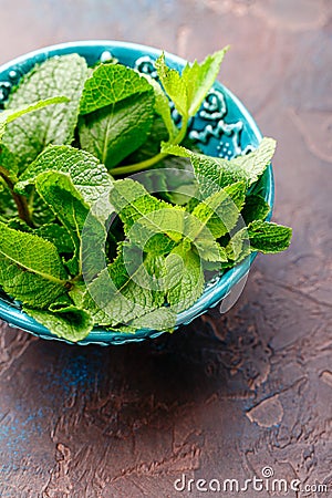 Fresh mint leaves in the ceramic bowl Stock Photo