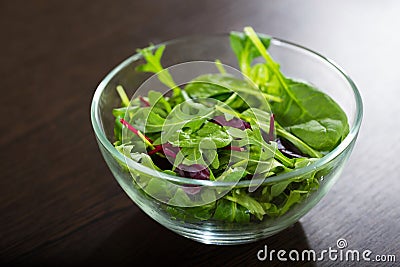 A fresh mixed salad on a wooden table. A notion of a useful and healthy meals Stock Photo