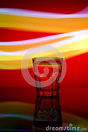 Fresh modern faceted glass on the colorful background Stock Photo