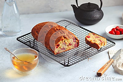 Fresh moist homemade delicious raspberry cake on black cooling rack Stock Photo