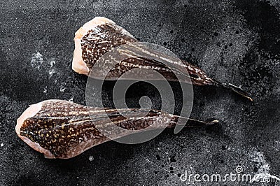 Fresh monkfish without a head. Black background. Top view Stock Photo