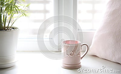 Fresh morning tea.Mug on window sill.Love word, valentine`s design background.Good mood concept Stock Photo