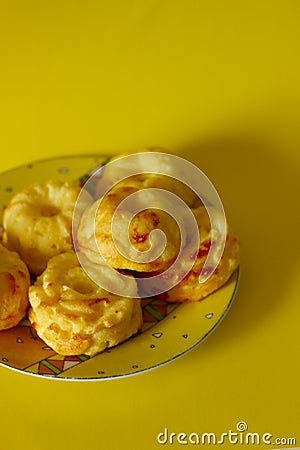 Fresh muffins on exquisite traditional plate on yellow backround Stock Photo