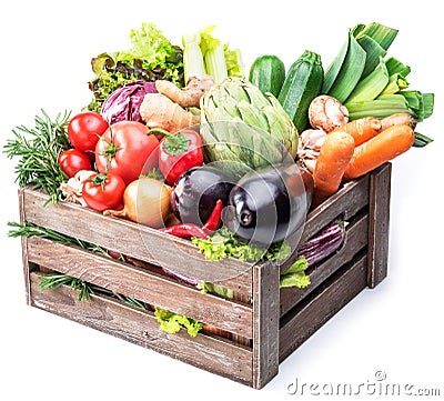 Fresh multi-colored vegetables in wooden crate. Stock Photo