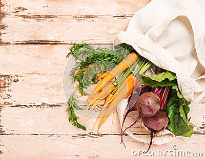 Fresh natural organic carrots beets bag made of cotton wooden rustic background. Natural eco friendly products concept. Stock Photo