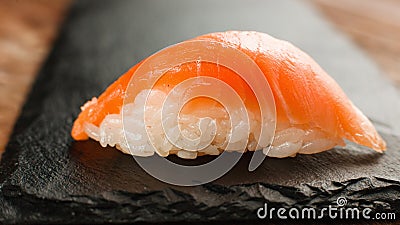 Fresh nigiri salmon sushi on black slate, close up Stock Photo