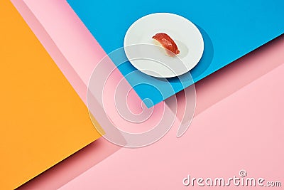 Fresh nigiri with tuna on blue, pink, orange background Stock Photo