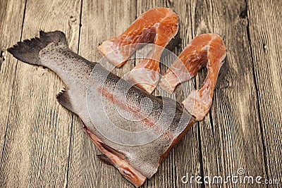 Fresh Norwegian rainbow trout steaks lying on the wooden background Stock Photo