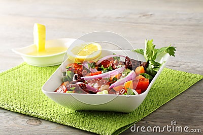 Fresh octopus salad with tomato and onion Stock Photo