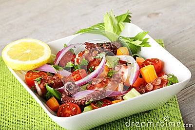 Fresh octopus salad with tomato and onion Stock Photo