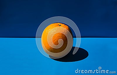Fresh orange lying on a blue background Stock Photo