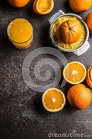 Fresh oranges juicer juice and tropical fruits on concrete board Stock Photo