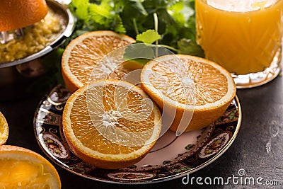 Fresh oranges juicer juice tropical fruits and herbs on concrete board Stock Photo