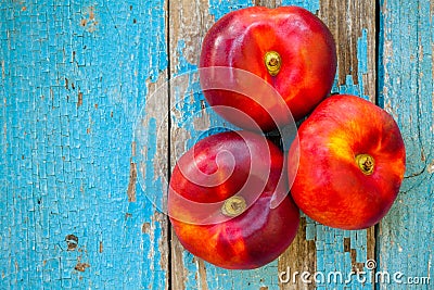 Fresh organic flat nectarines on an old wooden background Stock Photo